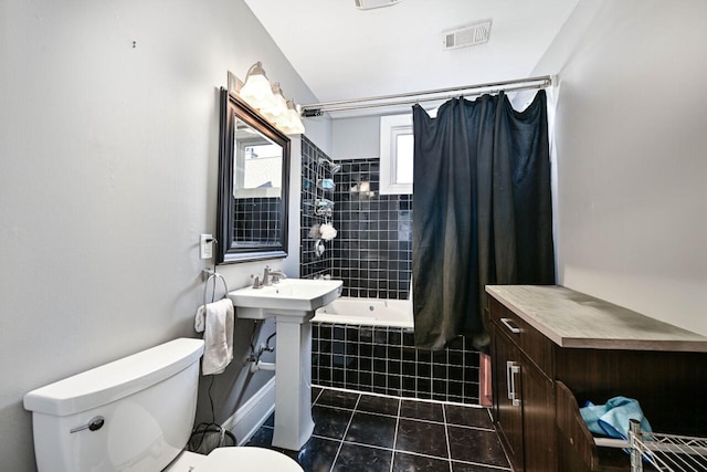 full bathroom with tile patterned flooring, shower / bath combination with curtain, toilet, and sink