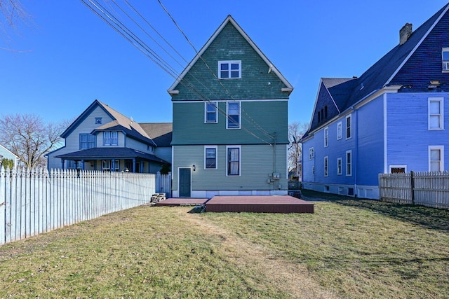 back of property featuring a lawn and a wooden deck