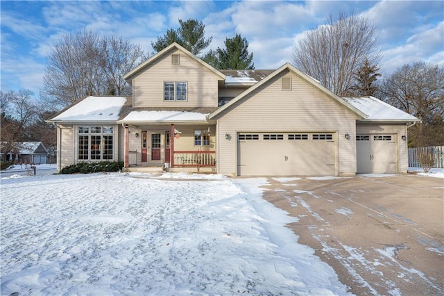 view of property featuring a porch and a garage