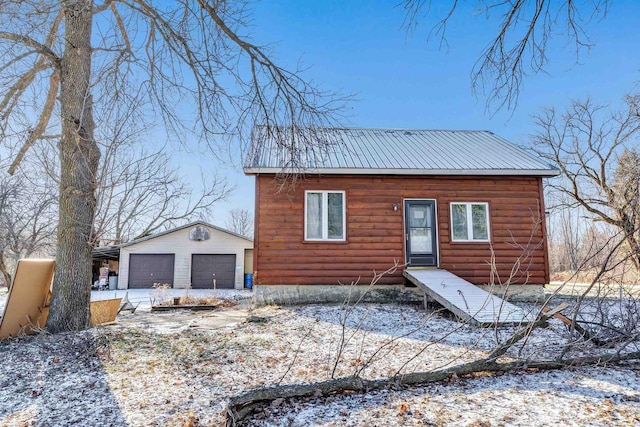 view of front of property with a garage and an outdoor structure