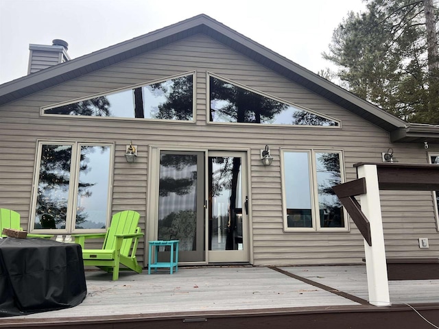 rear view of property with a wooden deck