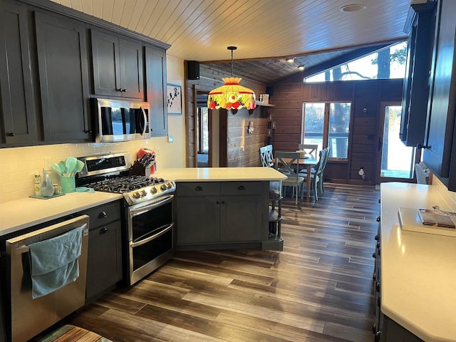 kitchen featuring appliances with stainless steel finishes, vaulted ceiling, dark wood-type flooring, decorative light fixtures, and wooden ceiling