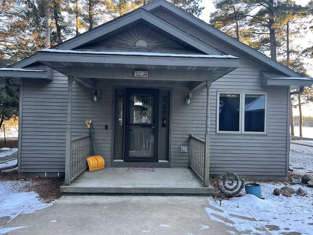 view of snow covered property entrance