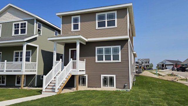 view of front of house featuring cooling unit and a front yard