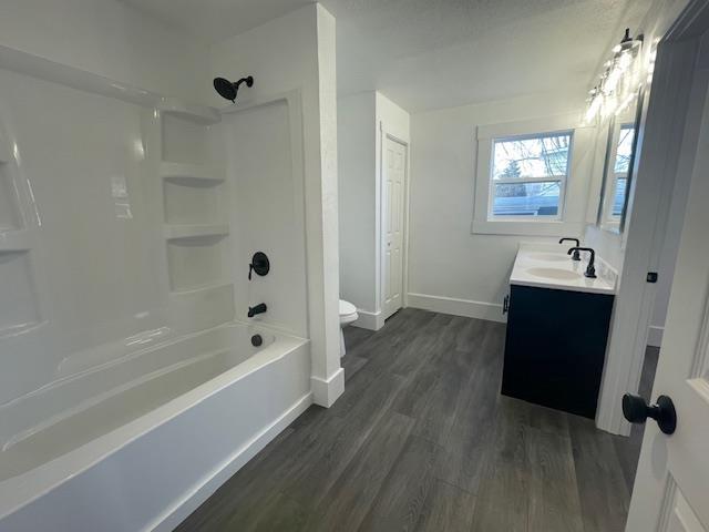 full bathroom featuring wood-type flooring, vanity, toilet, and shower / bathtub combination