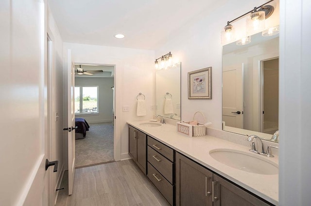 bathroom with ceiling fan, wood-type flooring, and vanity