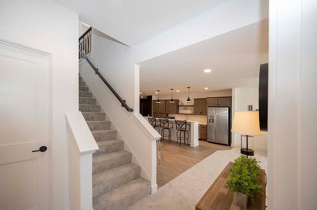 stairs featuring hardwood / wood-style flooring