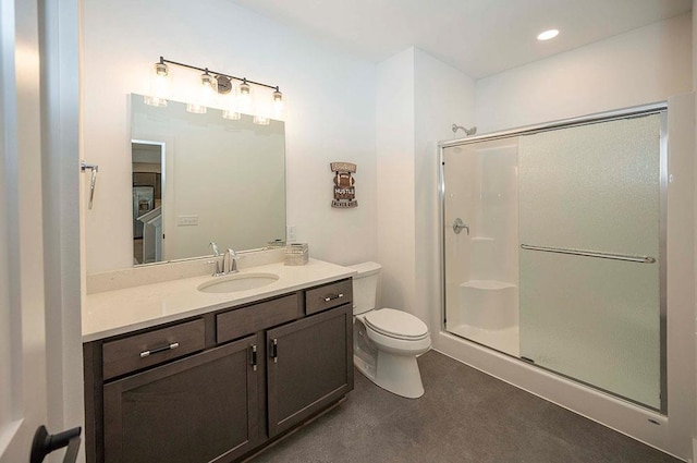 bathroom with vanity, toilet, and an enclosed shower