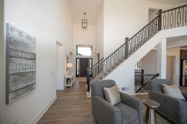 entrance foyer featuring a high ceiling and dark hardwood / wood-style flooring