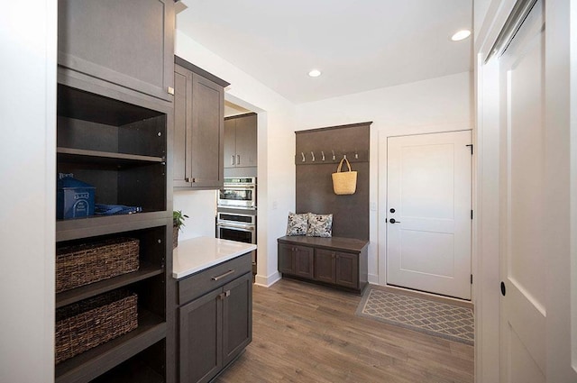 kitchen featuring dark hardwood / wood-style flooring and double oven