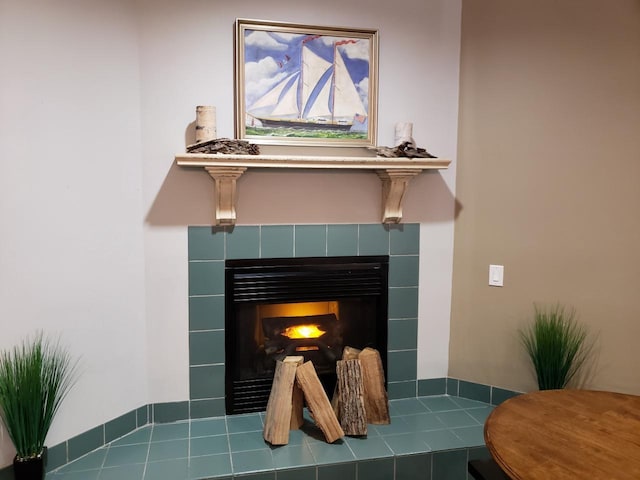 interior details featuring a tile fireplace