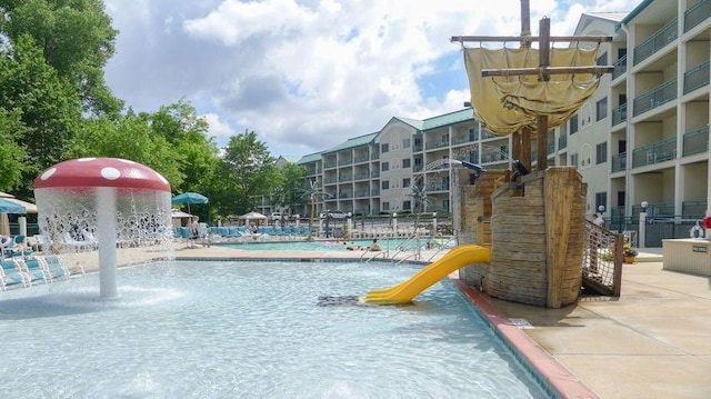 view of swimming pool with pool water feature