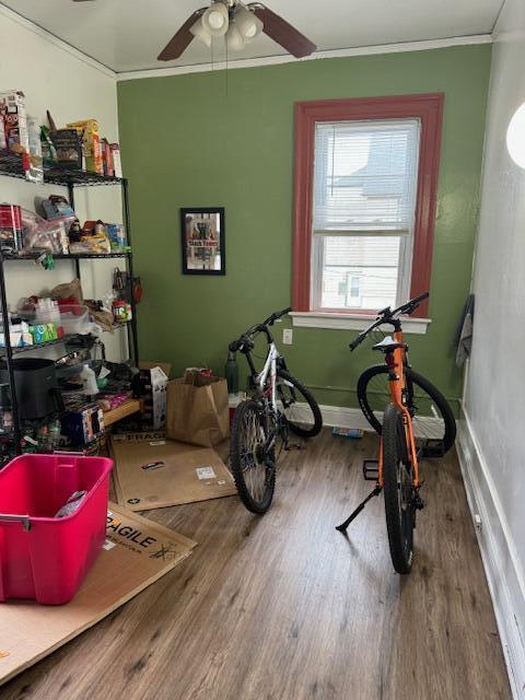 misc room with ceiling fan, hardwood / wood-style floors, and ornamental molding