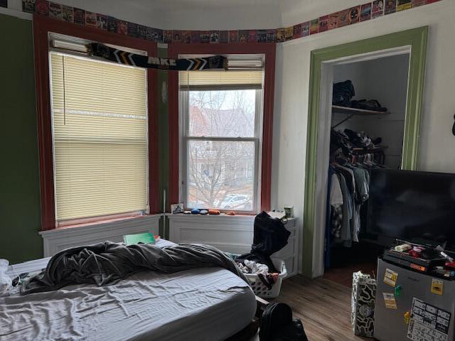 bedroom featuring hardwood / wood-style floors and a closet