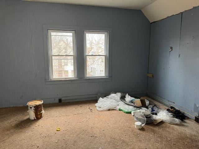 unfurnished room featuring vaulted ceiling