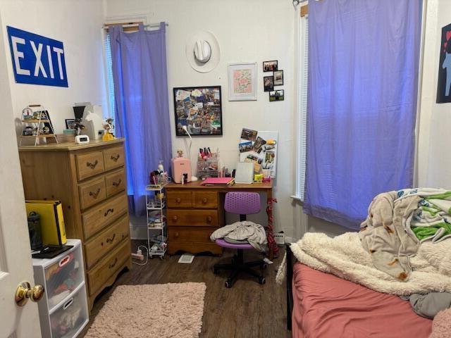 bedroom with dark hardwood / wood-style floors