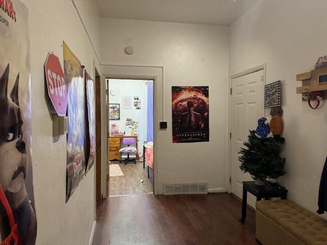 corridor with dark hardwood / wood-style flooring