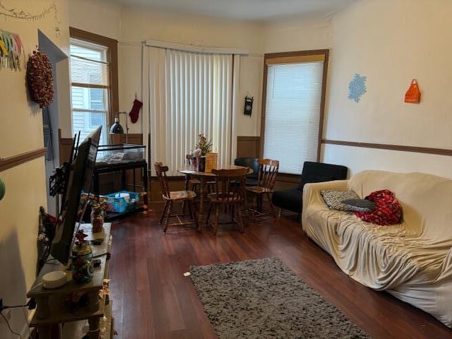 sitting room with dark wood-type flooring