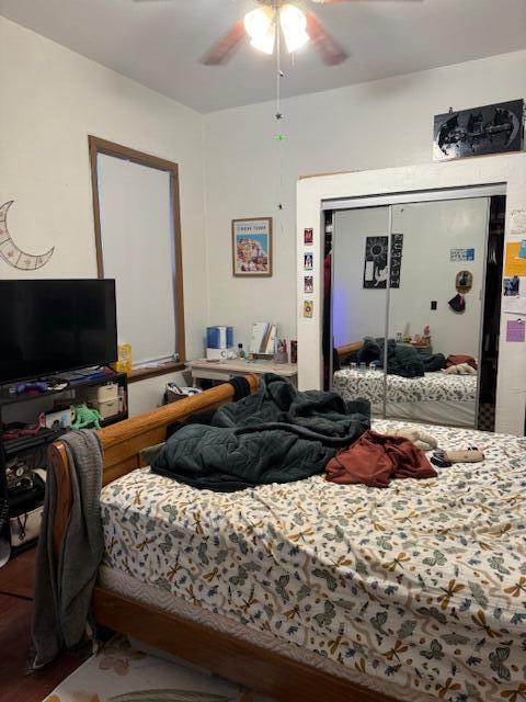 bedroom featuring hardwood / wood-style floors, a closet, and ceiling fan