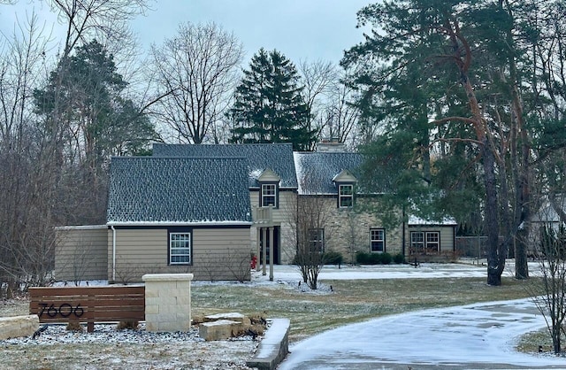 view of snow covered rear of property