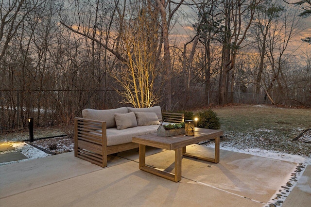 patio terrace at dusk featuring an outdoor living space