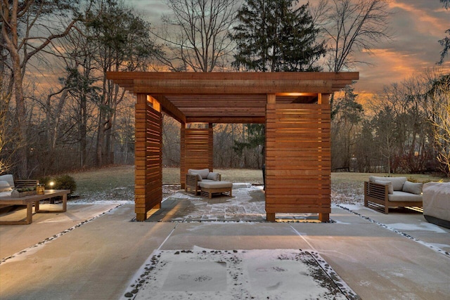 patio terrace at dusk with an outdoor living space and a pergola