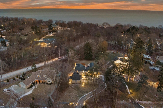 aerial view at dusk with a water view