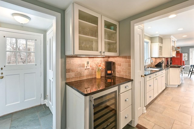 kitchen featuring sink, white cabinetry, wine cooler, decorative backsplash, and stainless steel dishwasher