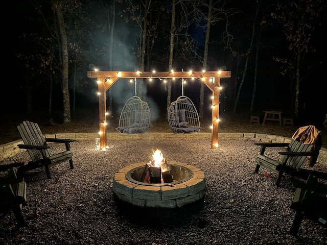 yard at twilight featuring an outdoor fire pit