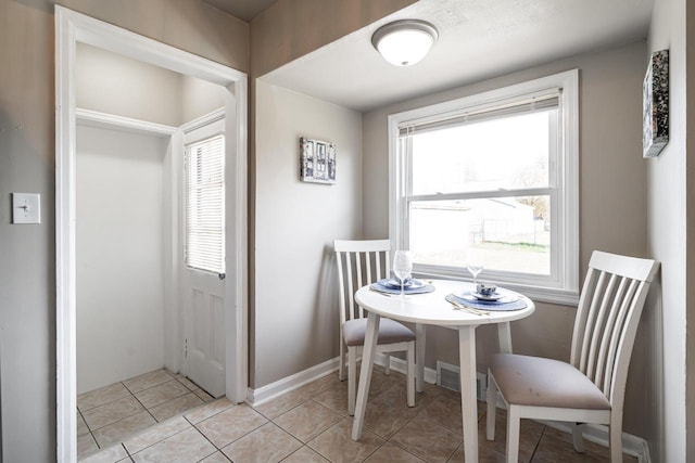 dining space with light tile patterned floors