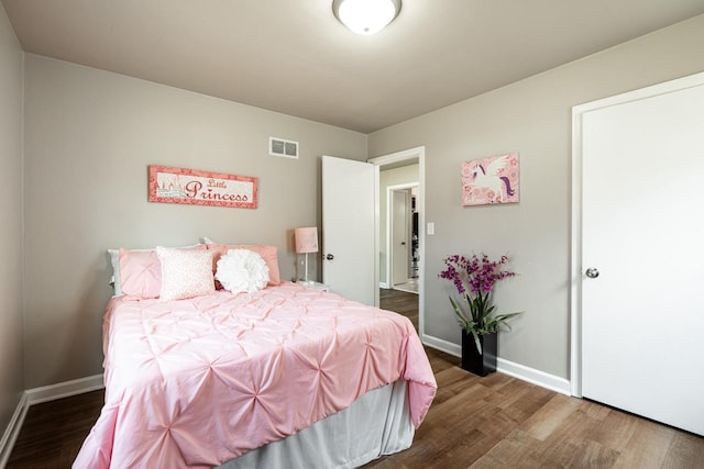 bedroom with dark wood-type flooring