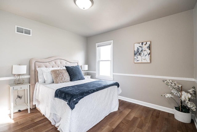 bedroom with dark hardwood / wood-style flooring