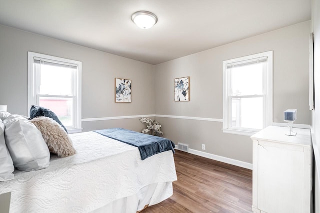 bedroom with hardwood / wood-style flooring