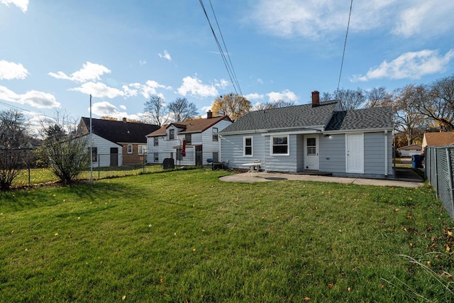 rear view of house with a lawn and a patio area