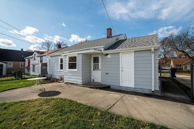 rear view of property with a patio area and a yard