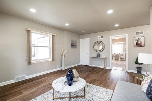 living room with dark hardwood / wood-style flooring