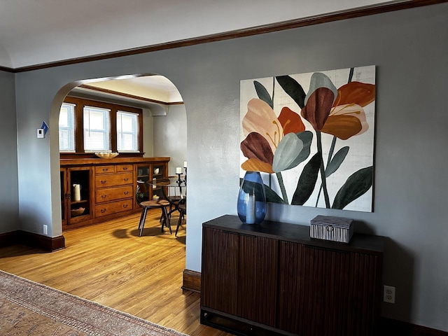 office with hardwood / wood-style floors and crown molding