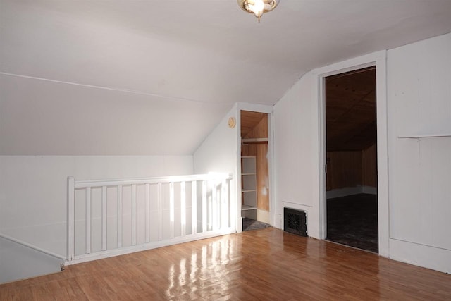 bonus room featuring hardwood / wood-style flooring and vaulted ceiling