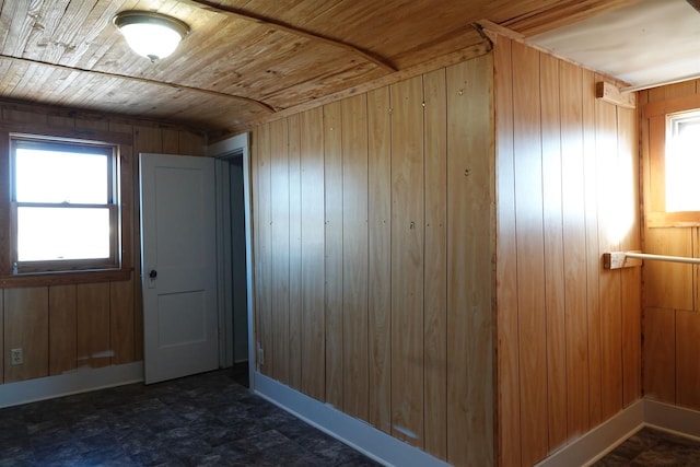 bonus room with wood walls and wooden ceiling