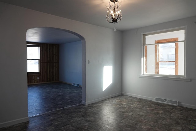 empty room featuring a chandelier