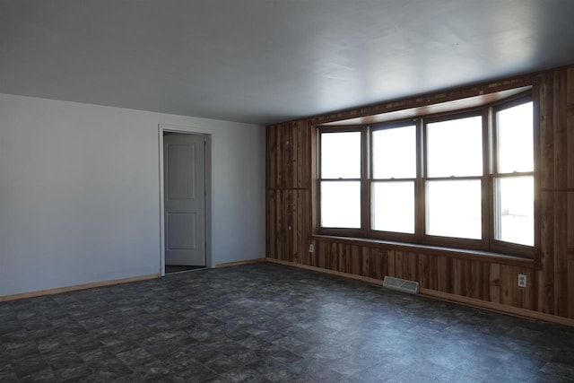 empty room with wood walls