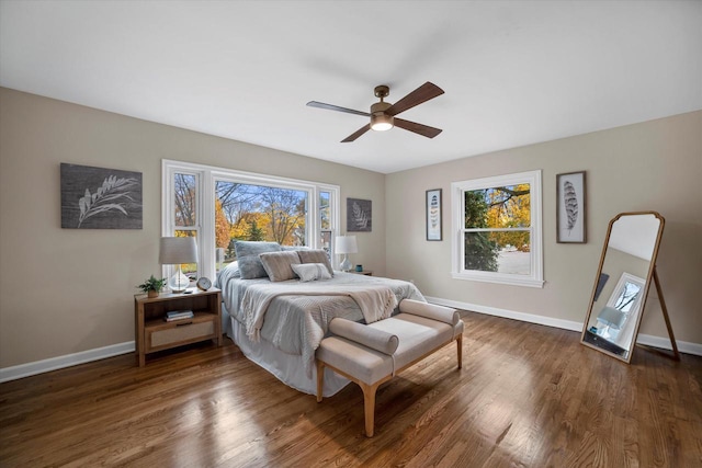 bedroom with ceiling fan and dark hardwood / wood-style flooring