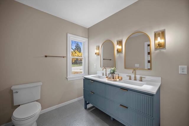 bathroom featuring tile patterned floors, vanity, and toilet