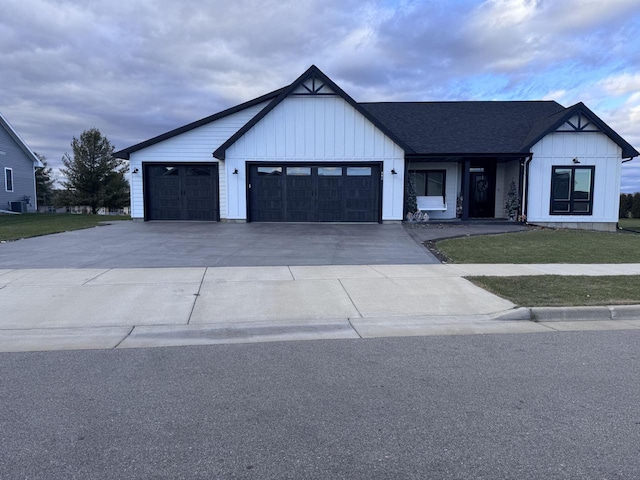 modern farmhouse with a front lawn and a garage