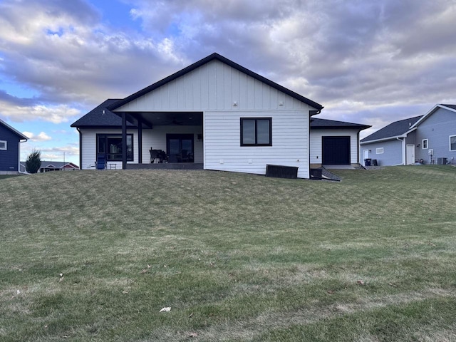 rear view of house featuring a lawn