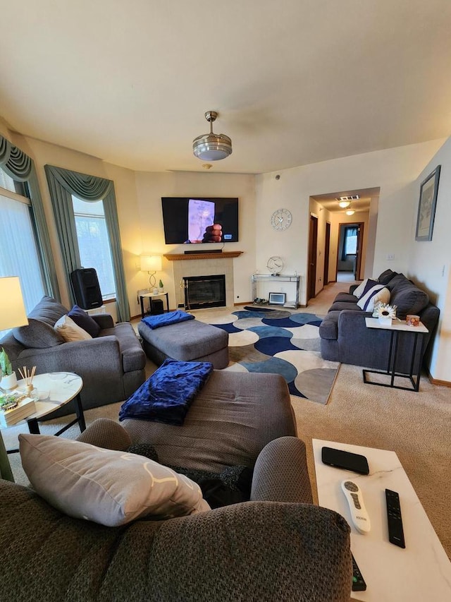 carpeted living room with a tiled fireplace