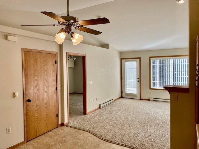 empty room featuring ceiling fan and a baseboard heating unit