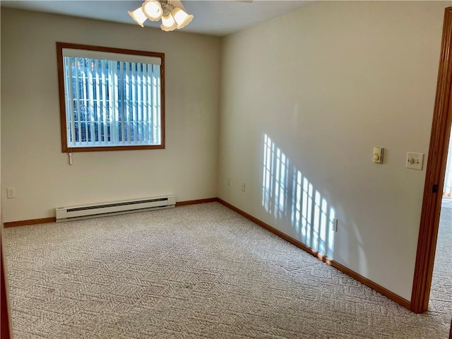 carpeted spare room with ceiling fan and a baseboard heating unit