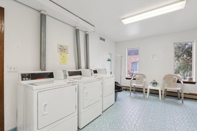 washroom featuring independent washer and dryer and baseboard heating