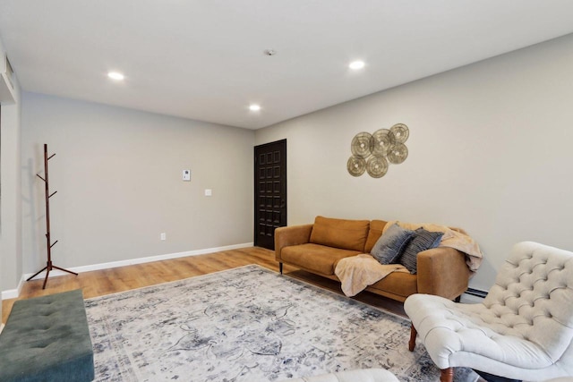 living room featuring hardwood / wood-style flooring and a baseboard radiator